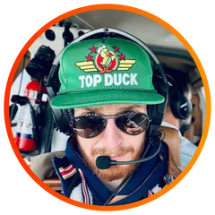 Sean Weaver, CarFilm founder, in a Top Duck cap and aviation headset.