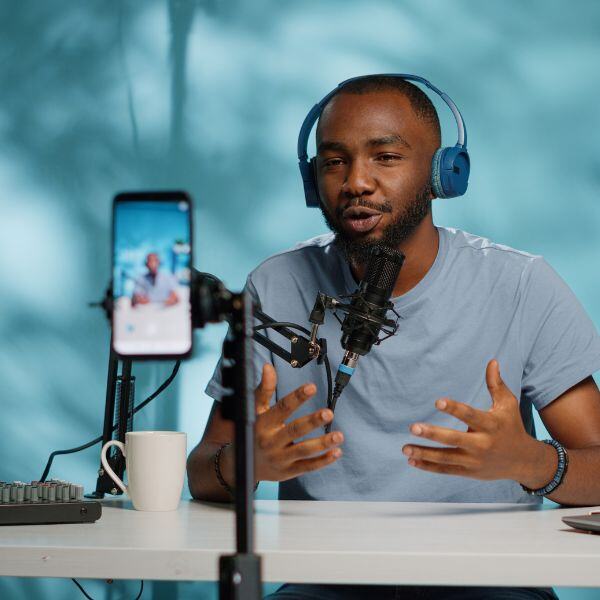 a man talking into a microphone while being recorded