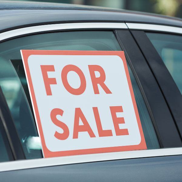 a for sale sign in a car window